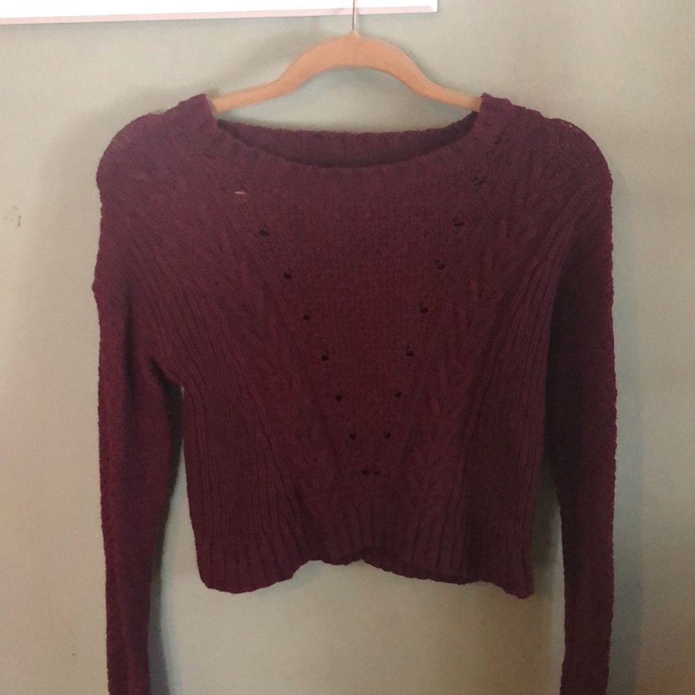 A maroon cropped knitted sweater